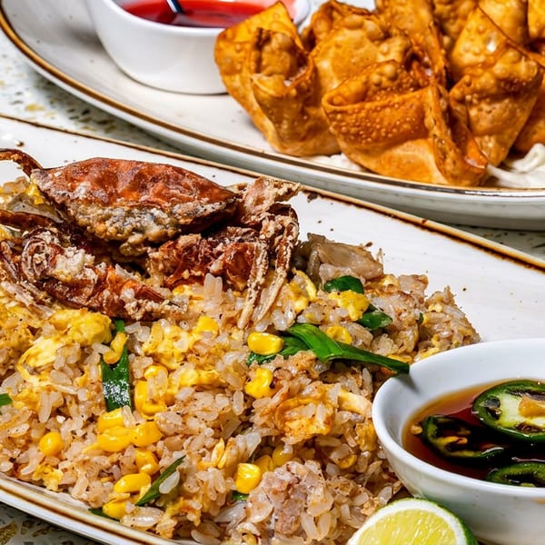 Crab fried rice with corn, green onions, jalapeño sauce, lime, and fried wontons.